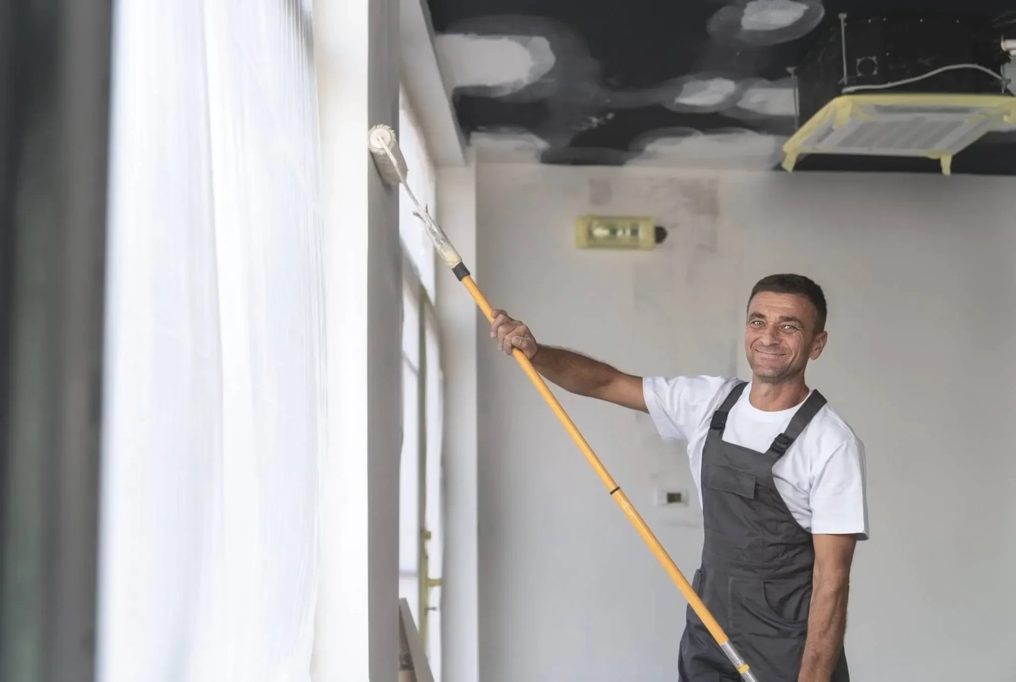 Man Painting Room Smiling Oakland County Michigan