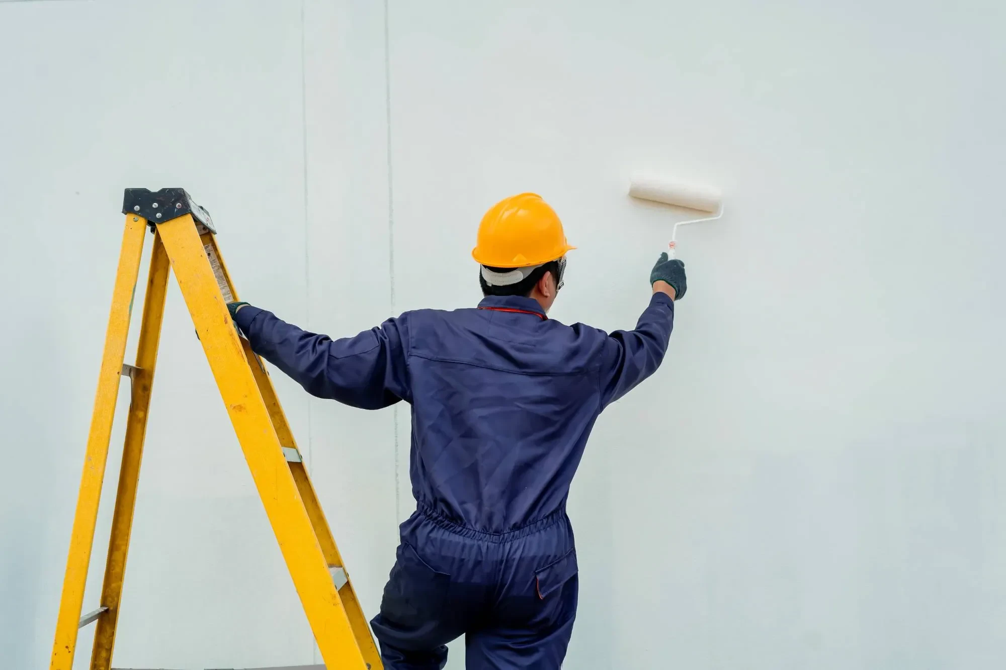 Worker Painting Wall Ladder Oakland County Michigan