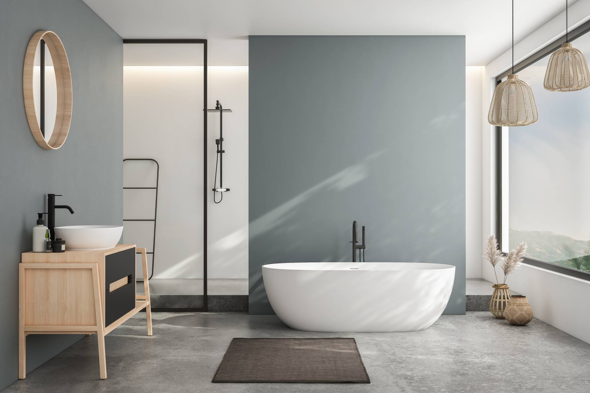 Modern bathroom in MI featuring a freestanding white tub, round mirror above a wooden vanity, glass shower enclosure, large window with natural light, and neutral decor—perfect inspiration from Painter Macomb & Oakland Counties.