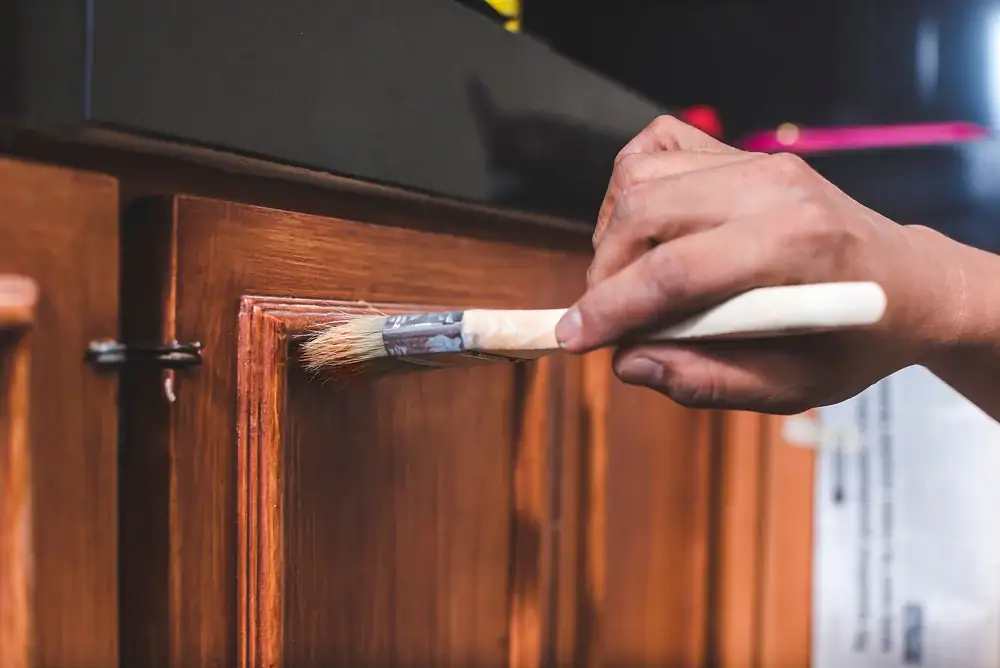 Professional painting of a wooden cabinet door in Oakland County, Michigan, showcasing a smooth, durable finish by Legends Painting’s expert team