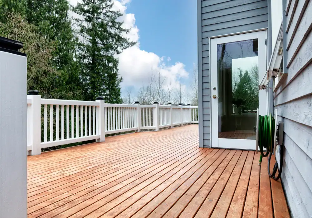 A beautiful, spacious wooden deck in Oakland County, Michigan, showcasing freshly stained wood and a welcoming outdoor atmosphere, perfect for relaxing and entertaining guests